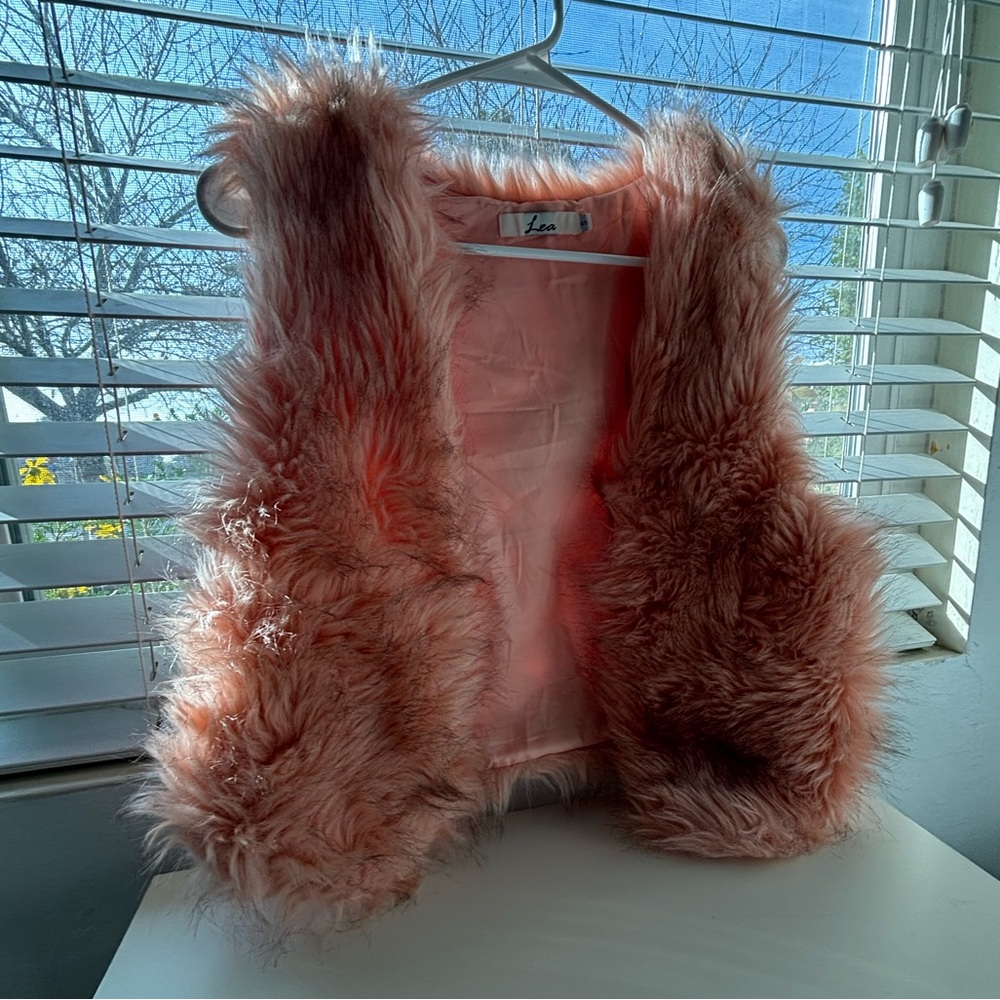 I’m selling a pink vest. The size is a small